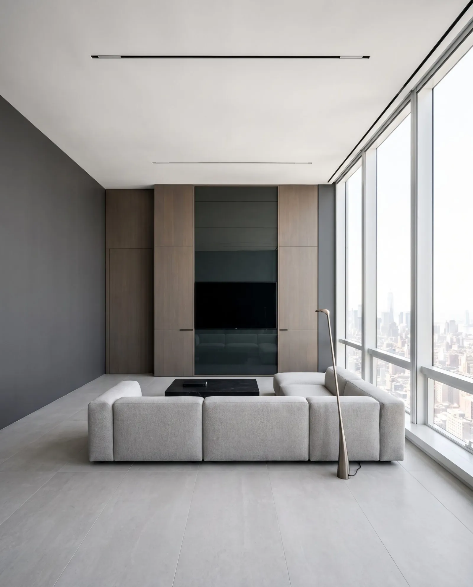A smoked oak wall with a screen behind tinted glass, in a high-rise living room